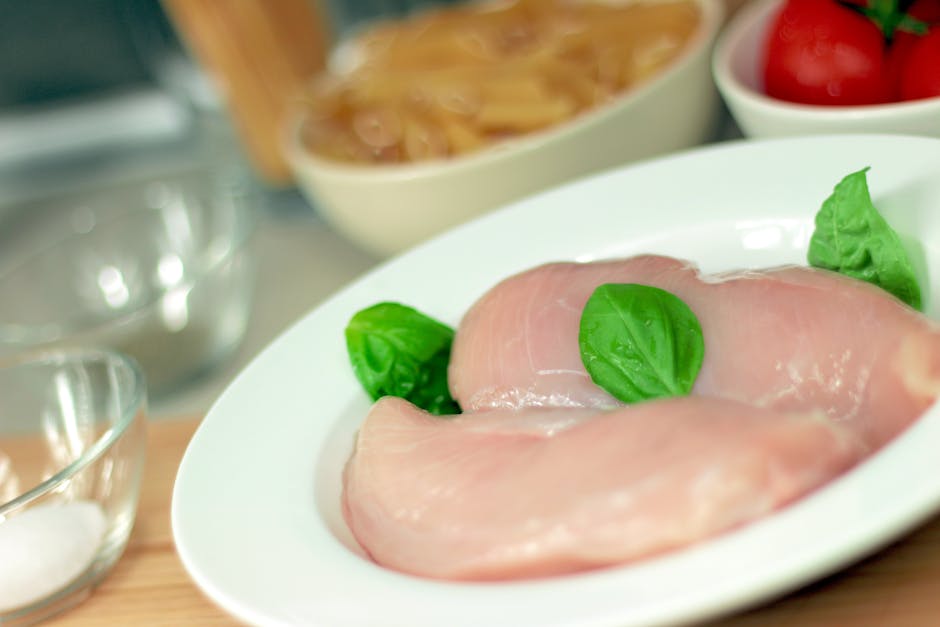 fresh raw chicken breast on a clean kitchen counter
