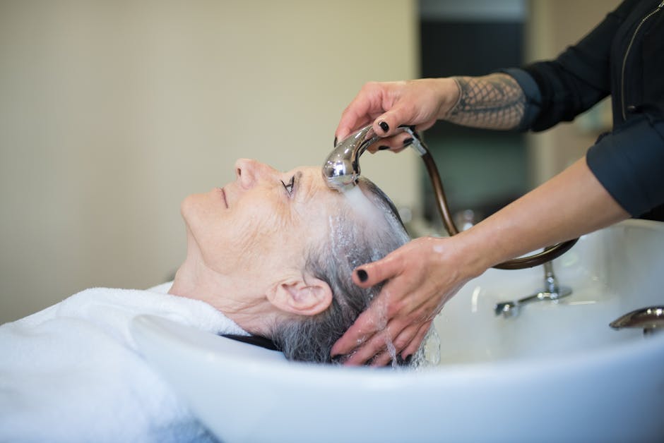 woman washing hair in salon shampoo bowl