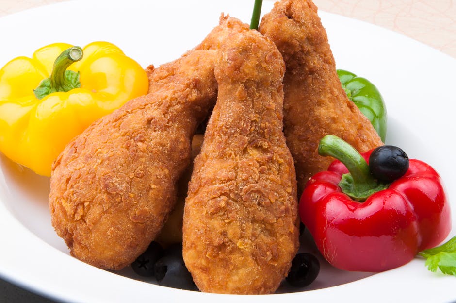 색색의 피망과 올리브를 곁들여 맛있게 튀긴 닭다리.