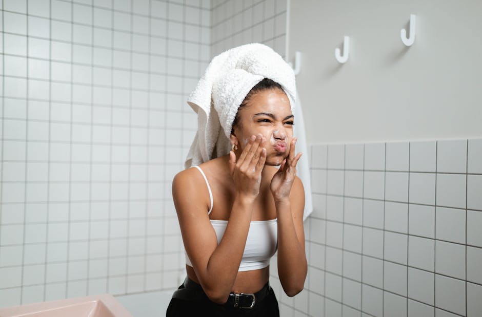 woman blow drying hair with brush in front of mirror