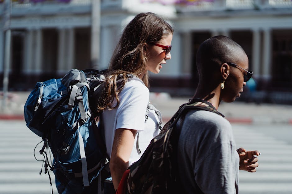 students walking with backpacks on city street