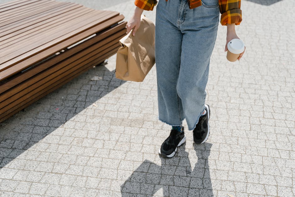 person walking with paper food bag