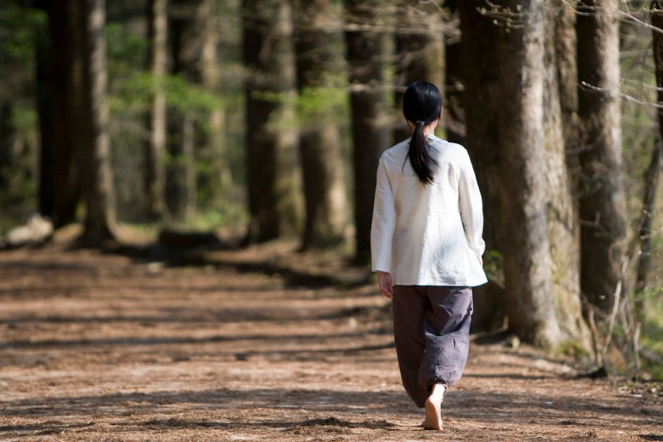 woman walking in sunny park morning