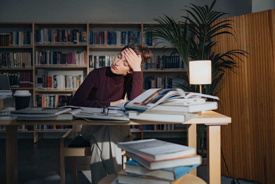 exhausted student studying late night desk