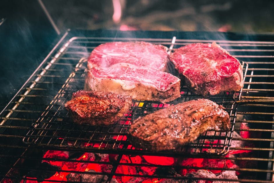grilling beef steak on charcoal